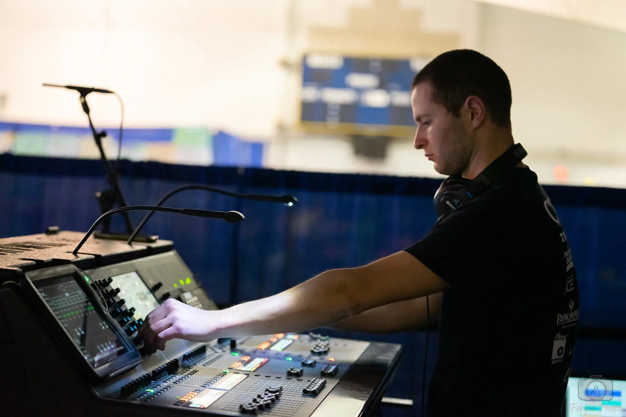 A crew engineer mixing sound at a digital console